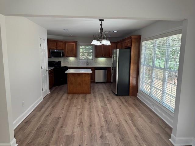 25 Jefferson Walk Circle Jefferson, GA 30549 - Photo 4 of 16 a kitchen with stainless steel appliances granite countertop a refrigerator a sink dishwasher a stove and a dining table with wooden floor