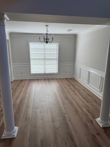 a view of room with wooden floor and fan