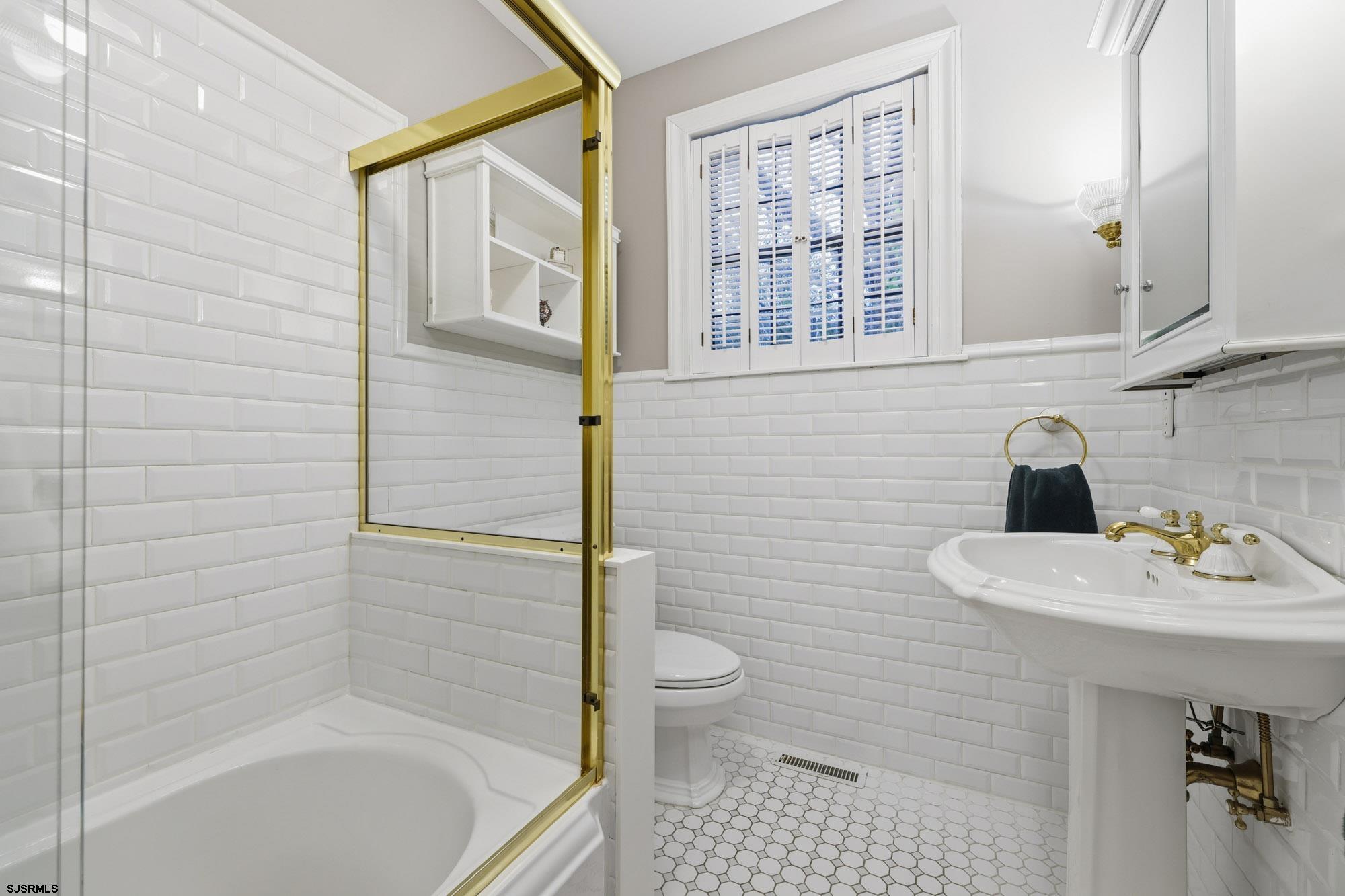 1202 Shore Road Northfield, NJ 08225 - Photo 21 of 57 a bathroom with a sink a toilet and shower