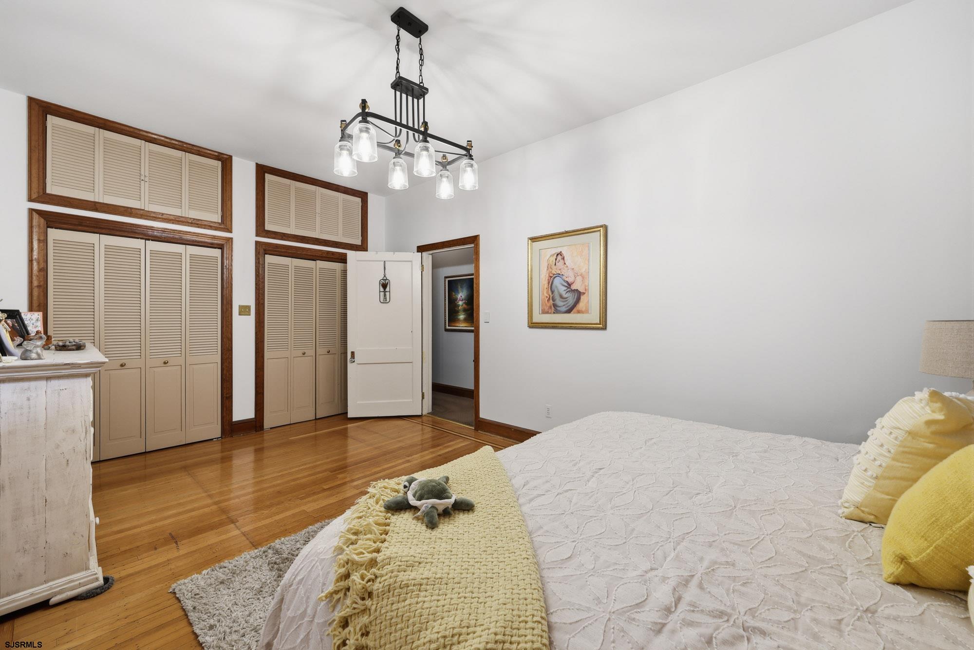 1202 Shore Road Northfield, NJ 08225 - Photo 27 of 57 a bedroom with a bed chandelier and a window