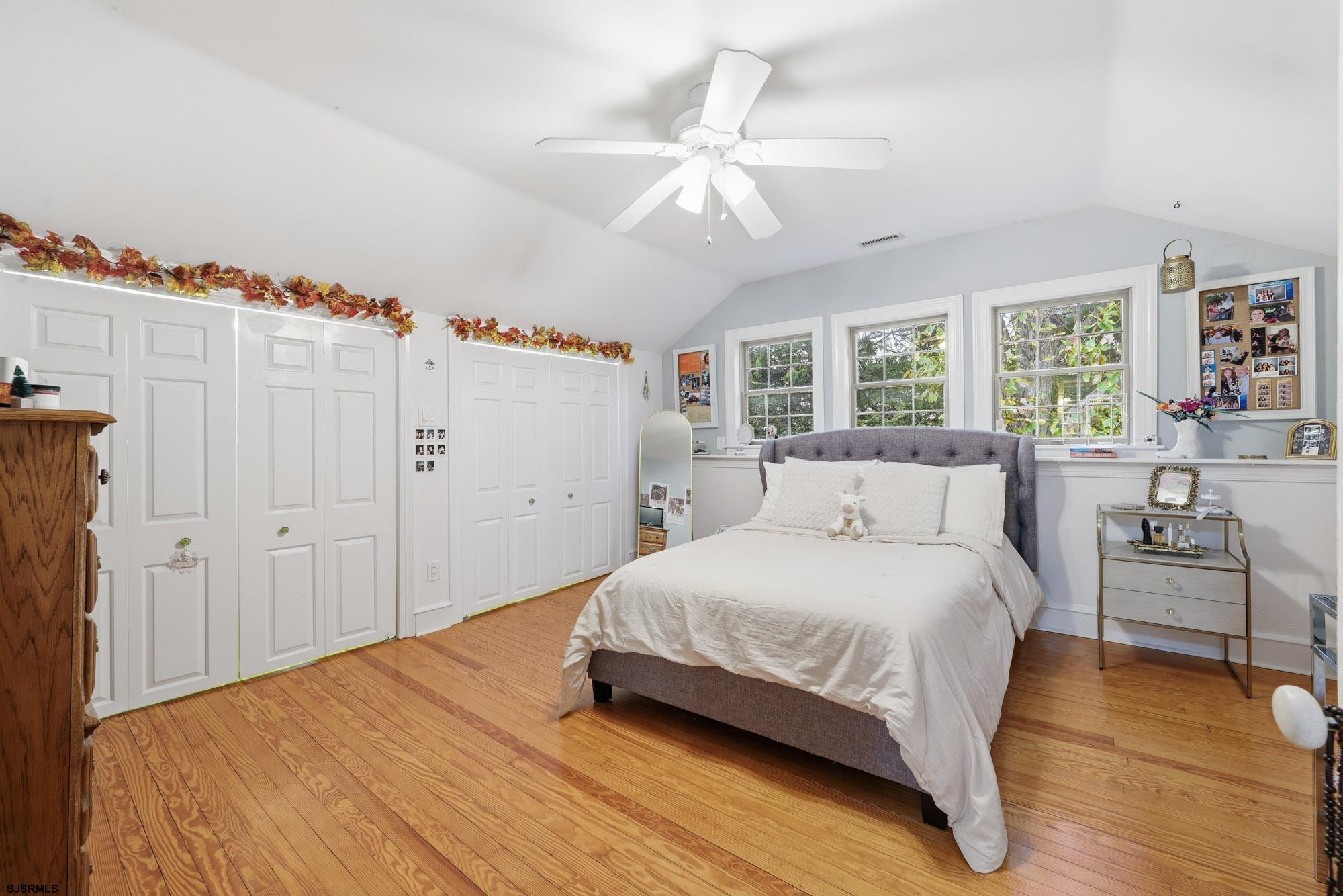 1202 Shore Road Northfield, NJ 08225 - Photo 32 of 57 a bedroom with a bed and a chandelier