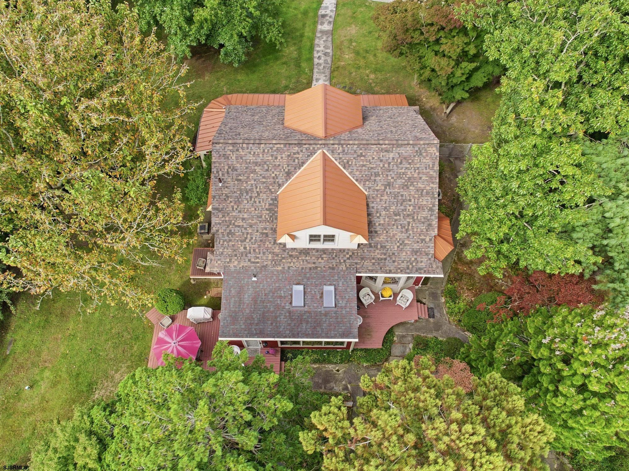 1202 Shore Road Northfield, NJ 08225 - Photo 51 of 57 a front view of a house with a yard and fountain in middle