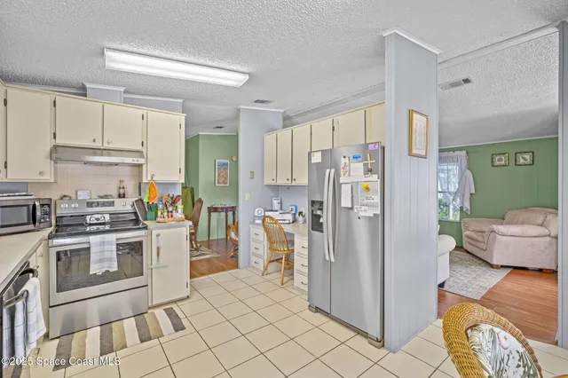a kitchen with stainless steel appliances a refrigerator sink and stove