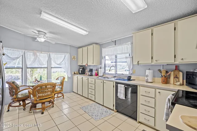 a kitchen with a stove a sink and cabinets