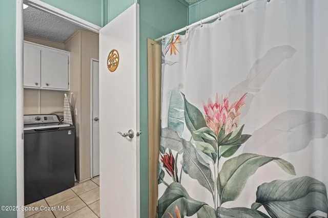 a view of a hallway with furniture and a potted plant
