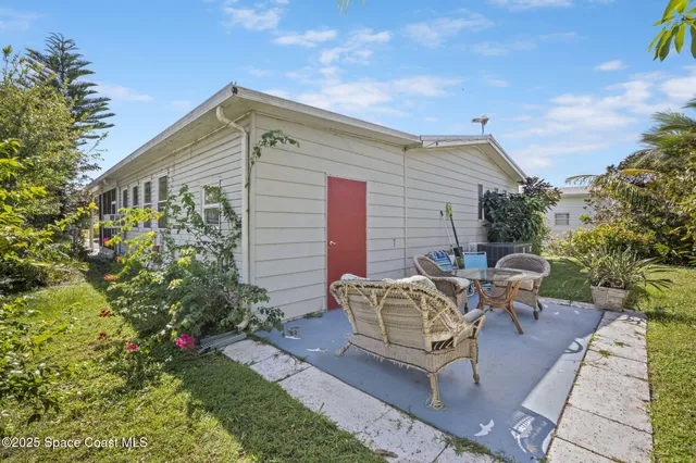 a view of a patio with table and chairs with wooden fence