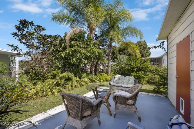 a wooden bench sitting in a backyard of a house