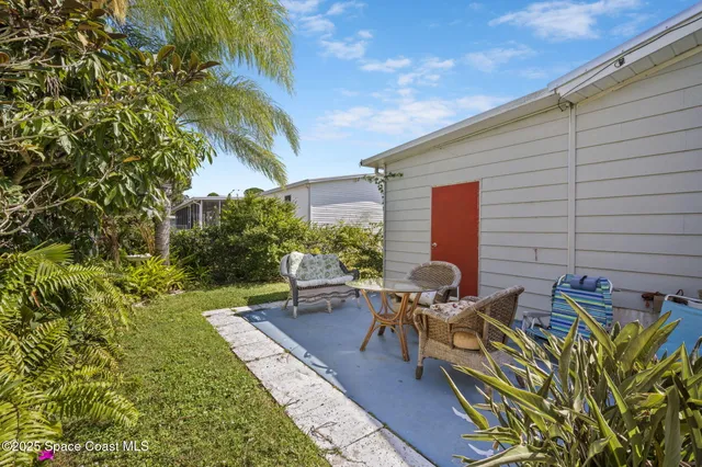 a view of a backyard with sitting area