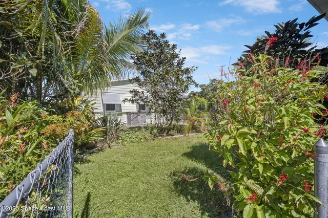a yellow building with trees in front of it