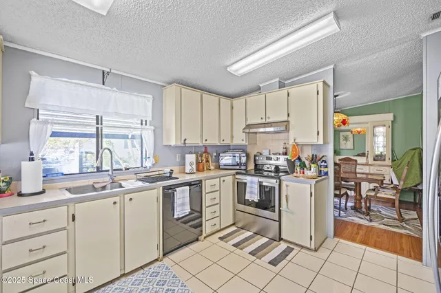 a kitchen with cabinets appliances and a window