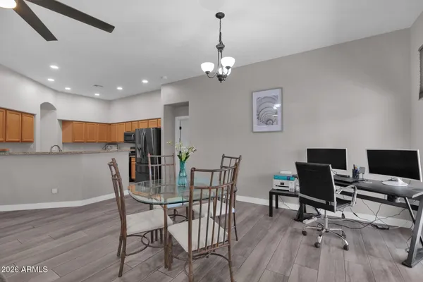 a living room with furniture a chandelier and a dining room