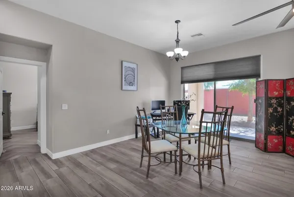 a view of a dining room with furniture and wooden floor