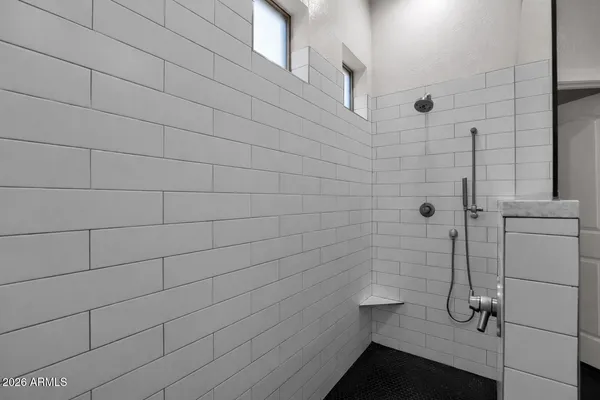 a spacious bathroom with a double vanity sink and a mirror