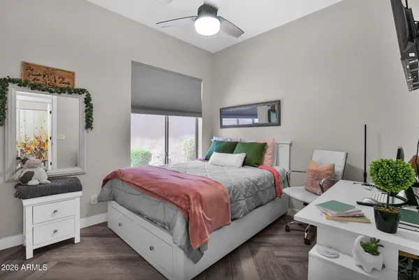 a bedroom with a bed a couch and a window