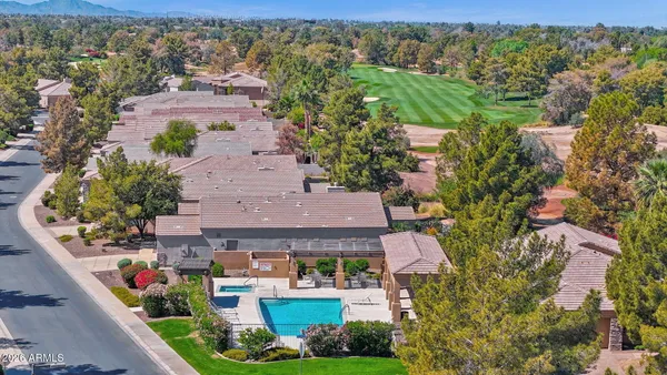 an aerial view of house with yard swimming pool and outdoor seating