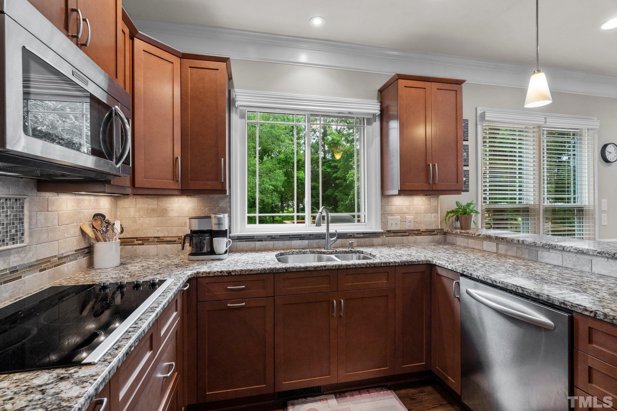 102 Sequoia Court Cary, NC 27513 - Photo 15 of 36 a kitchen with a sink stove top oven and cabinets