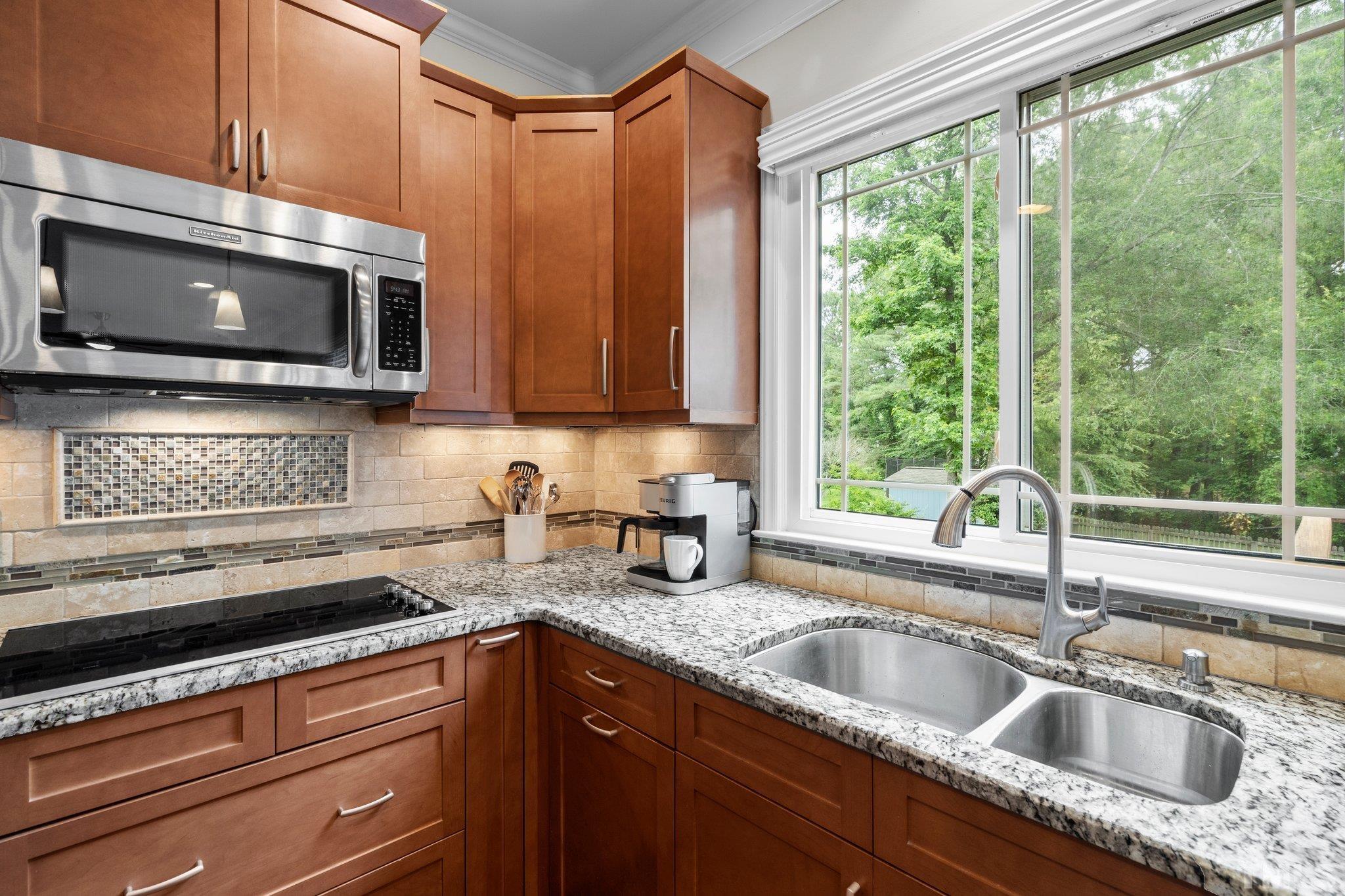 102 Sequoia Court Cary, NC 27513 - Photo 18 of 36 a kitchen with stainless steel appliances granite countertop a sink a microwave cabinets and a window