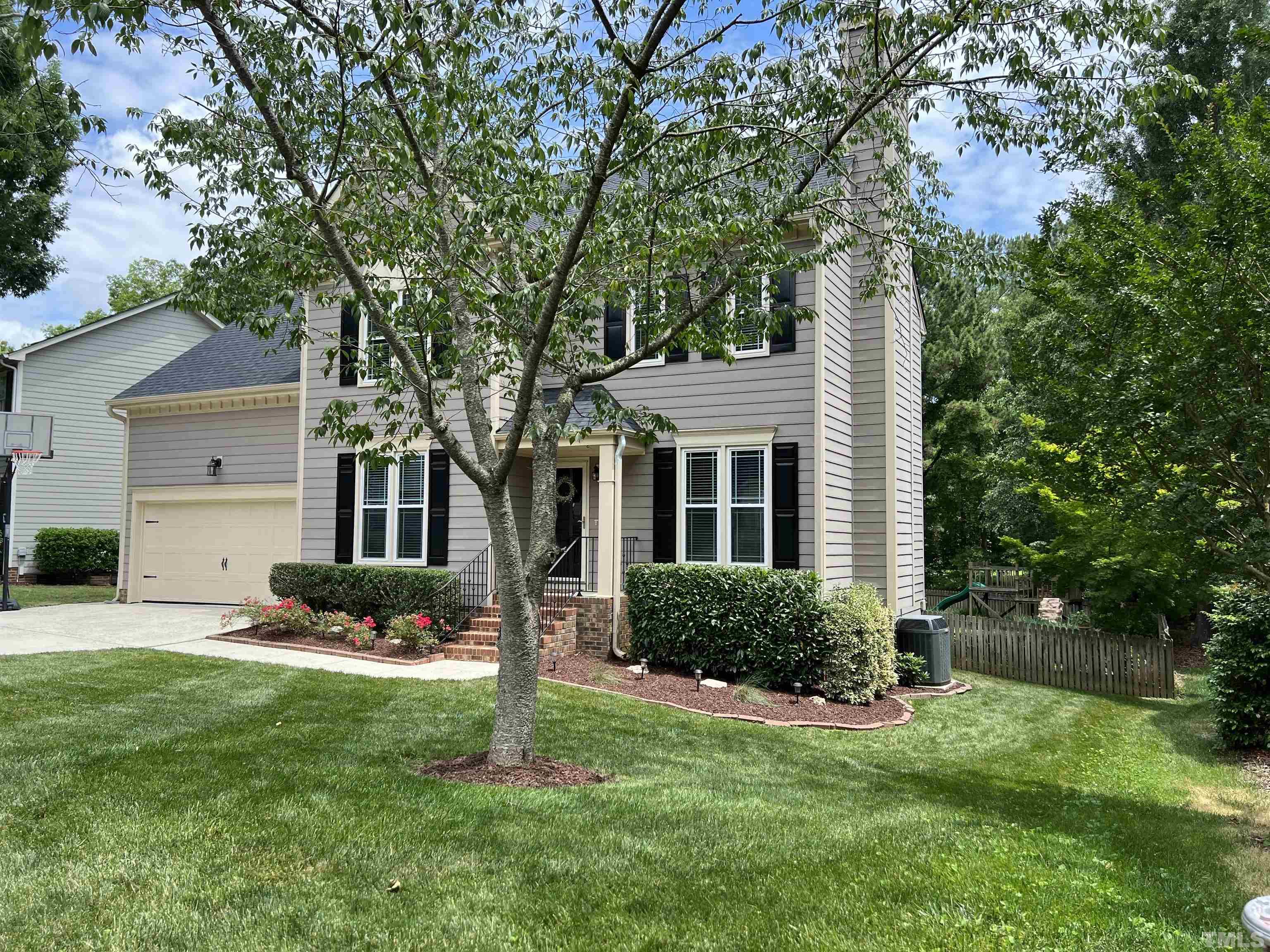 102 Sequoia Court Cary, NC 27513 - Photo 2 of 36 a front view of a house with a yard and trees