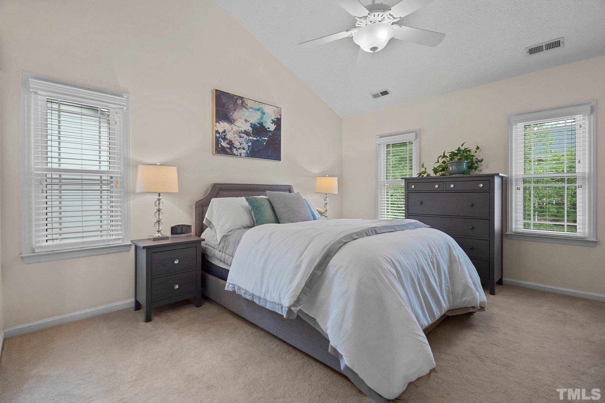 102 Sequoia Court Cary, NC 27513 - Photo 30 of 36 a spacious bedroom with a bed and a chandelier