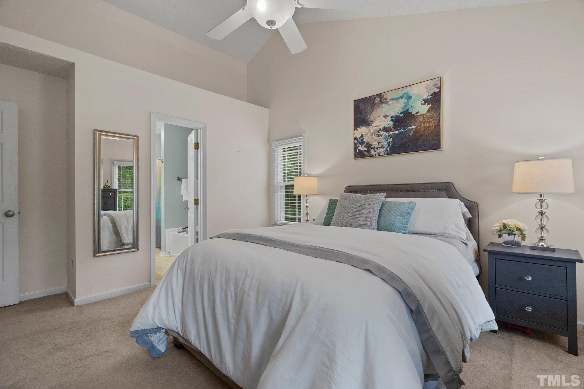 102 Sequoia Court Cary, NC 27513 - Photo 35 of 36 a spacious bedroom with a bed and a chandelier