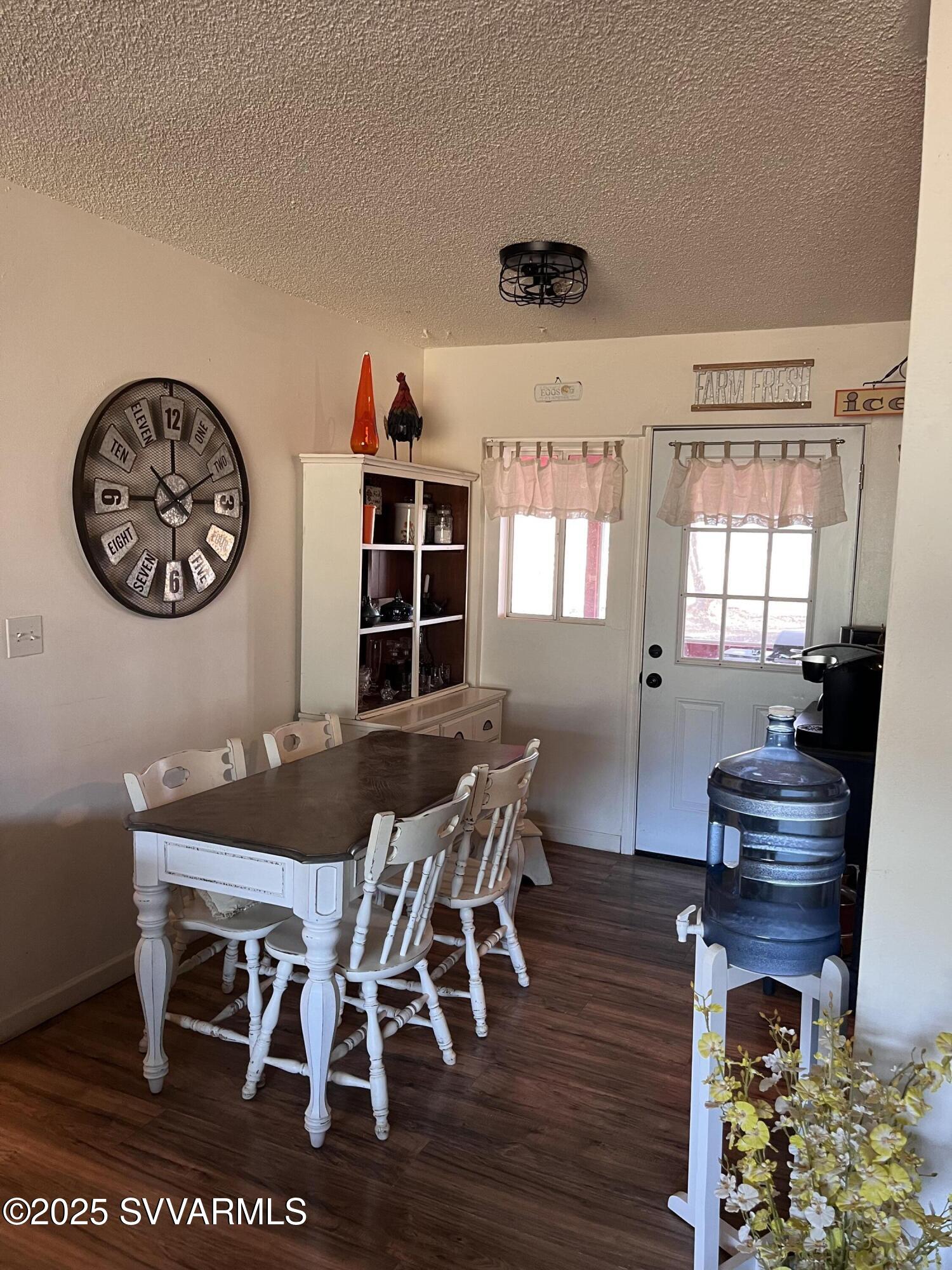 3405 South Silver Road Camp Verde, AZ 86322 - Photo 12 of 56 a view of a dining room with furniture and wooden floor