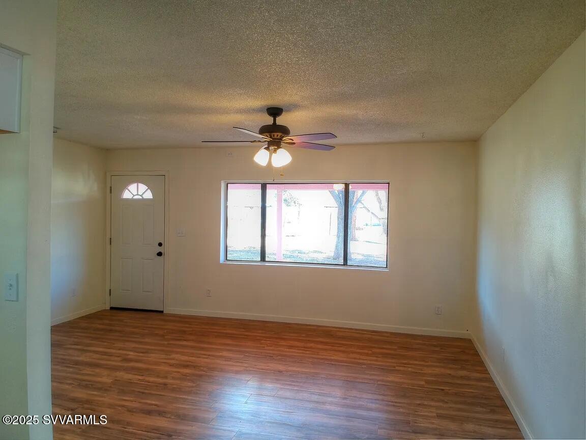 3405 South Silver Road Camp Verde, AZ 86322 - Photo 21 of 56 a view of an empty room with wooden floor and a window