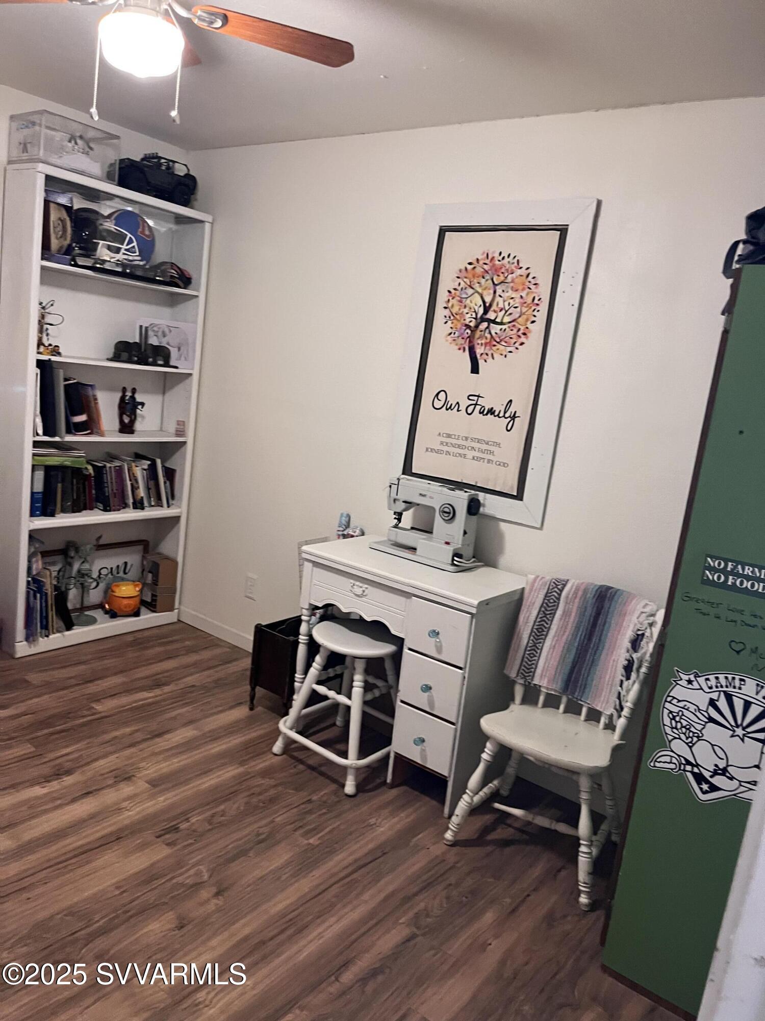 3405 South Silver Road Camp Verde, AZ 86322 - Photo 37 of 56 a room with furniture a rug and a book shelf