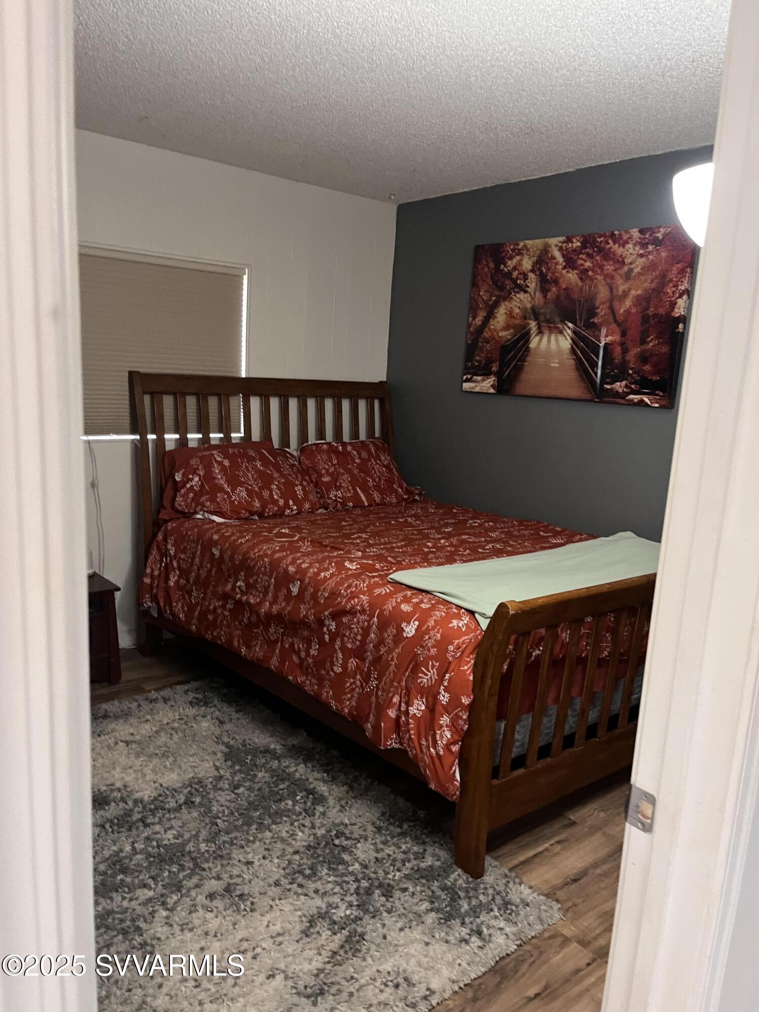 3405 South Silver Road Camp Verde, AZ 86322 - Photo 39 of 56 a bedroom with a bed and wall painting