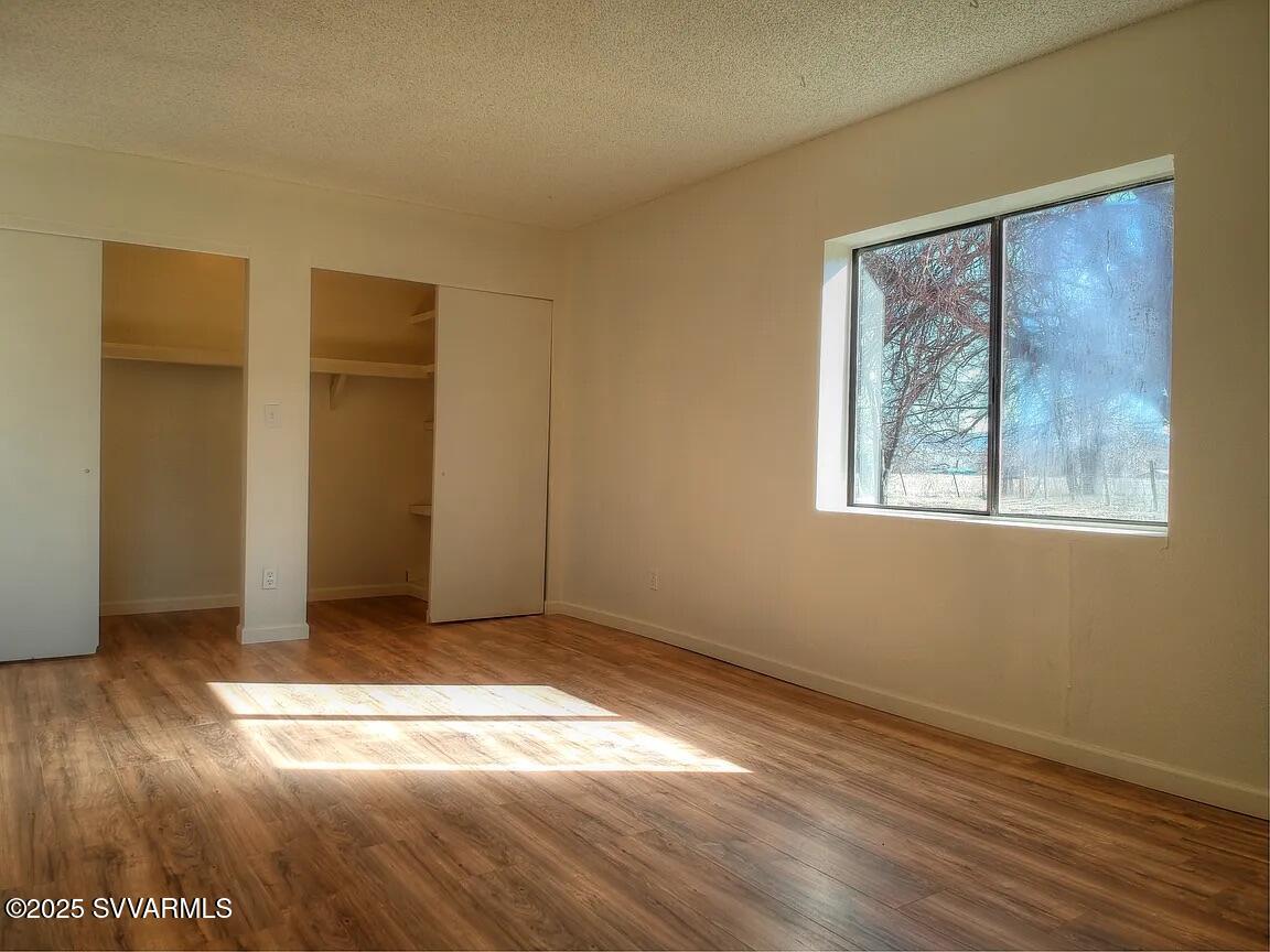 3405 South Silver Road Camp Verde, AZ 86322 - Photo 48 of 56 a view of an empty room with wooden floor and a window