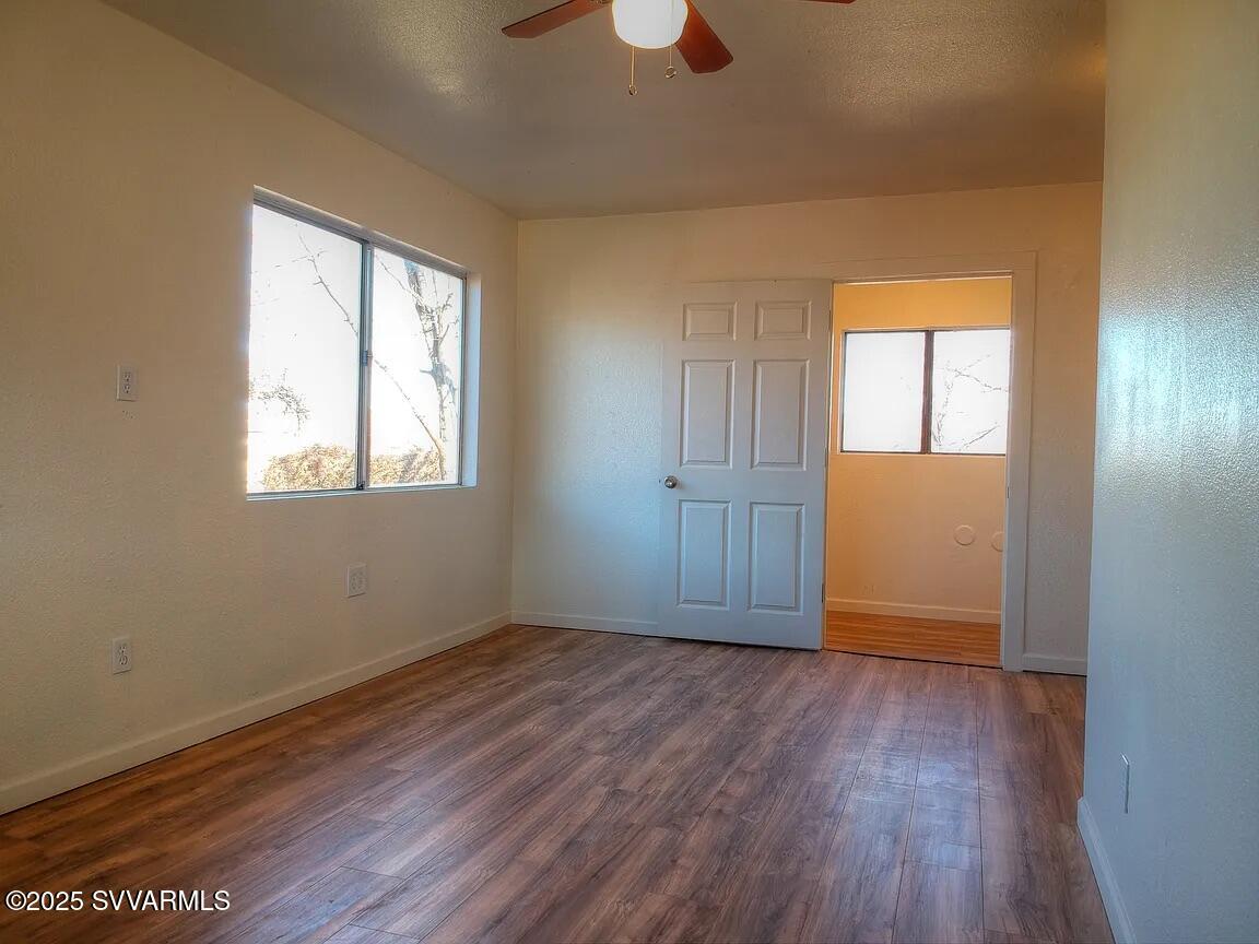 3405 South Silver Road Camp Verde, AZ 86322 - Photo 49 of 56 an empty room with wooden floor cabinet and windows