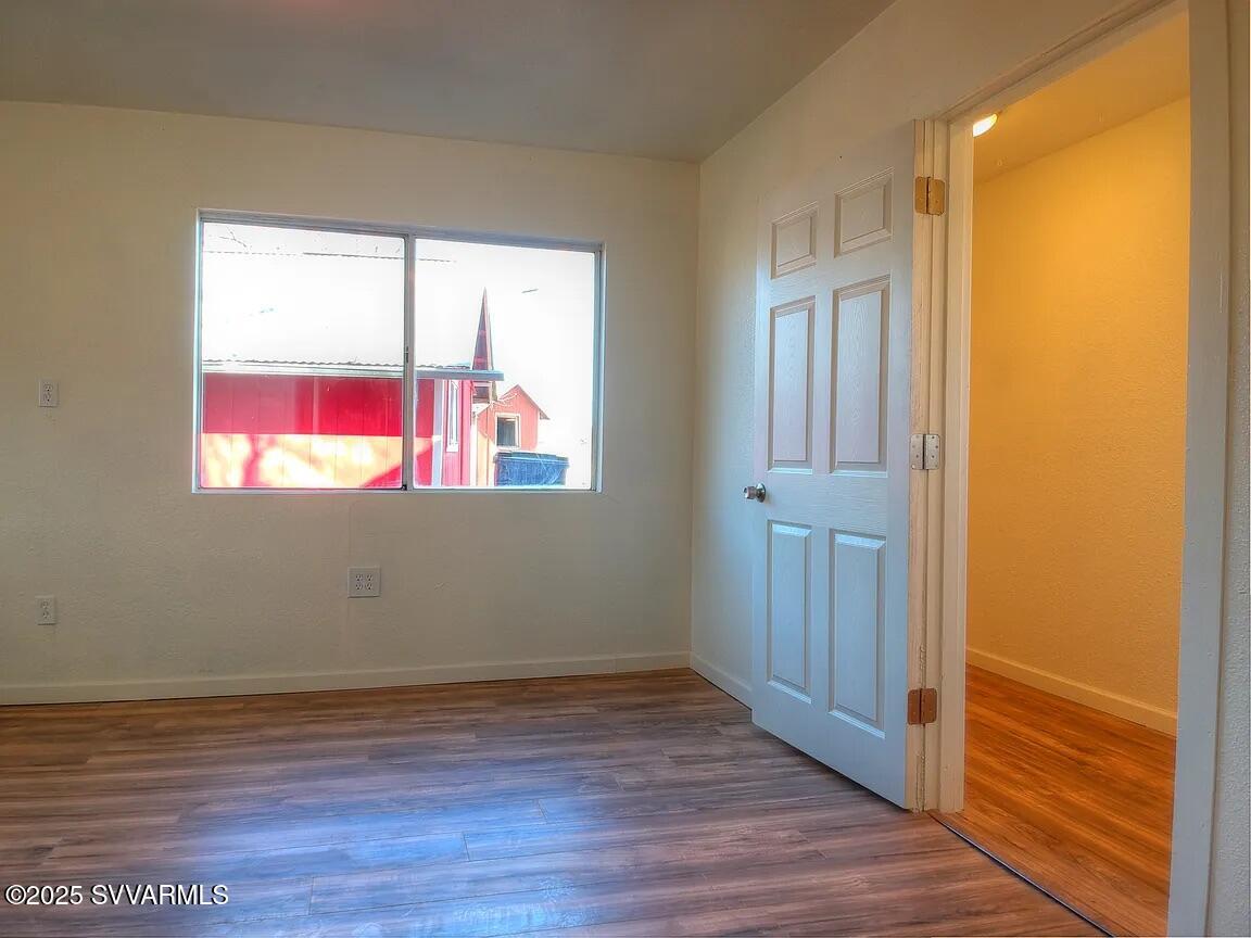 3405 South Silver Road Camp Verde, AZ 86322 - Photo 50 of 56 a view of an empty room with wooden floor and a window