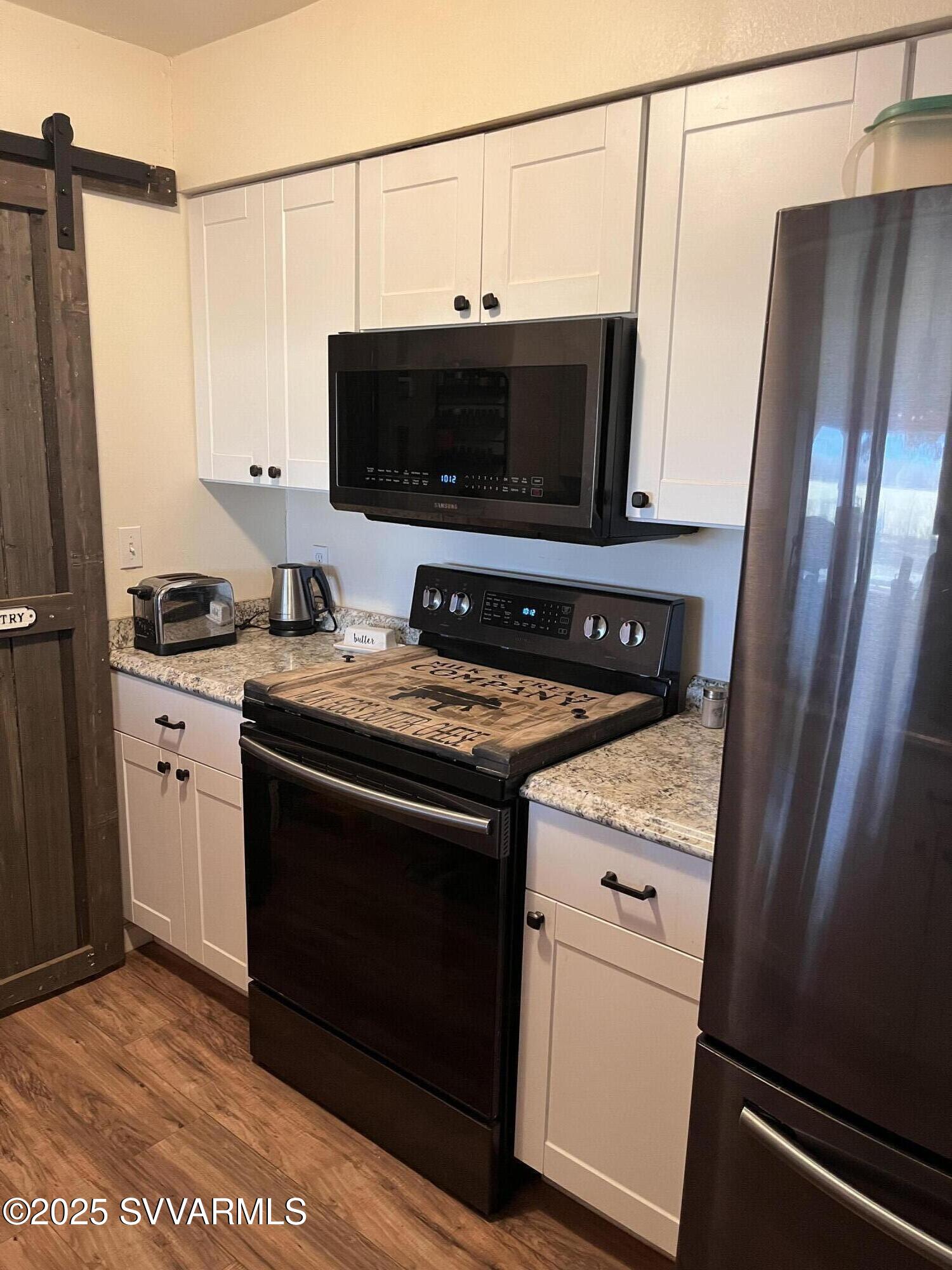 3405 South Silver Road Camp Verde, AZ 86322 - Photo 9 of 56 a kitchen with stainless steel appliances a stove a microwave a sink and a refrigerator