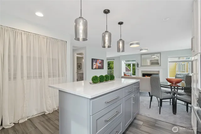 a view of living room with kitchen island furniture and wooden floor