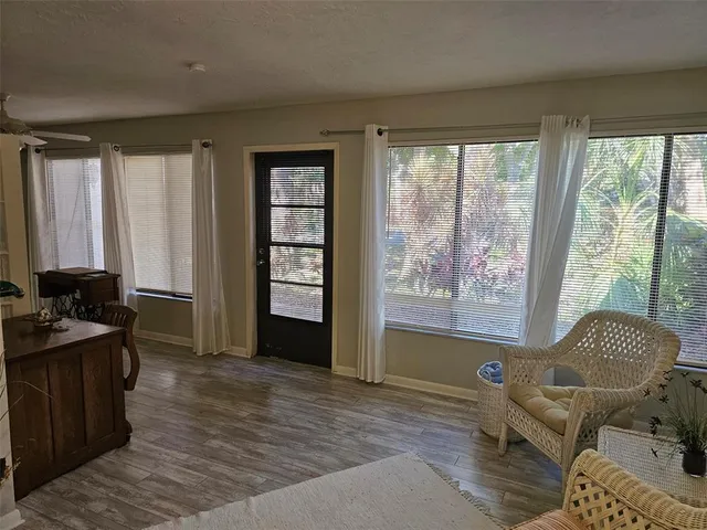 a living room with furniture and a floor to ceiling window