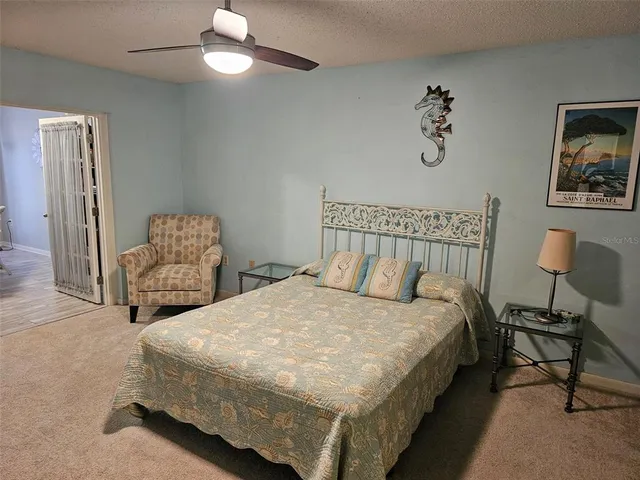 a bedroom with double bed and a chair