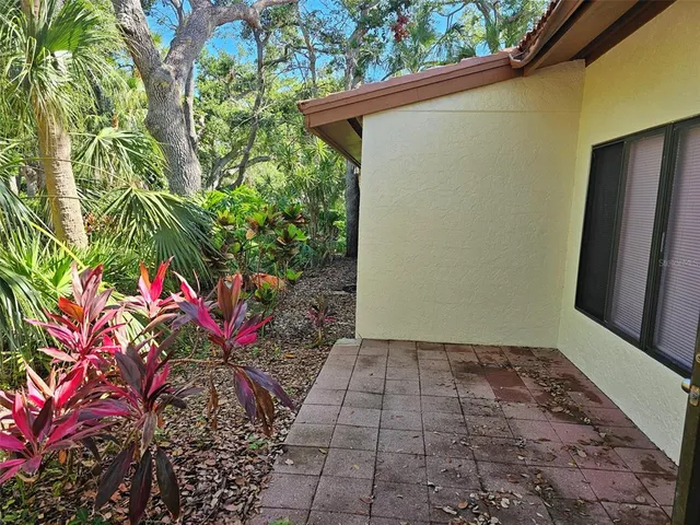 a backyard of a house with flowers