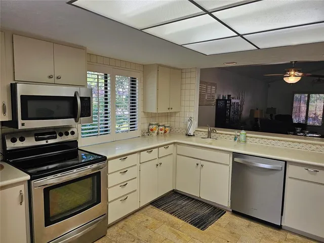 a kitchen with a sink stove and microwave