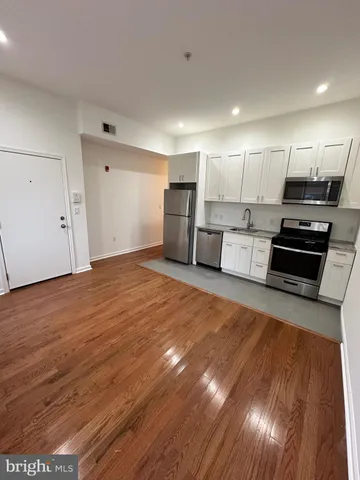 a view of kitchen with wooden floor