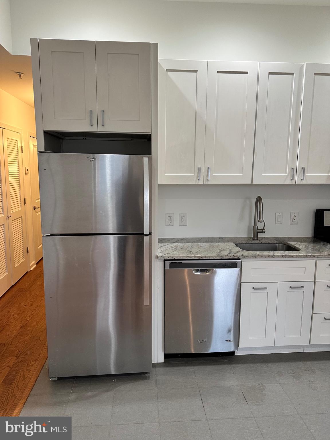 1128 South 19th Street, Unit A Philadelphia, PA 19146 - Photo 4 of 17 a kitchen with a refrigerator a sink and cabinets