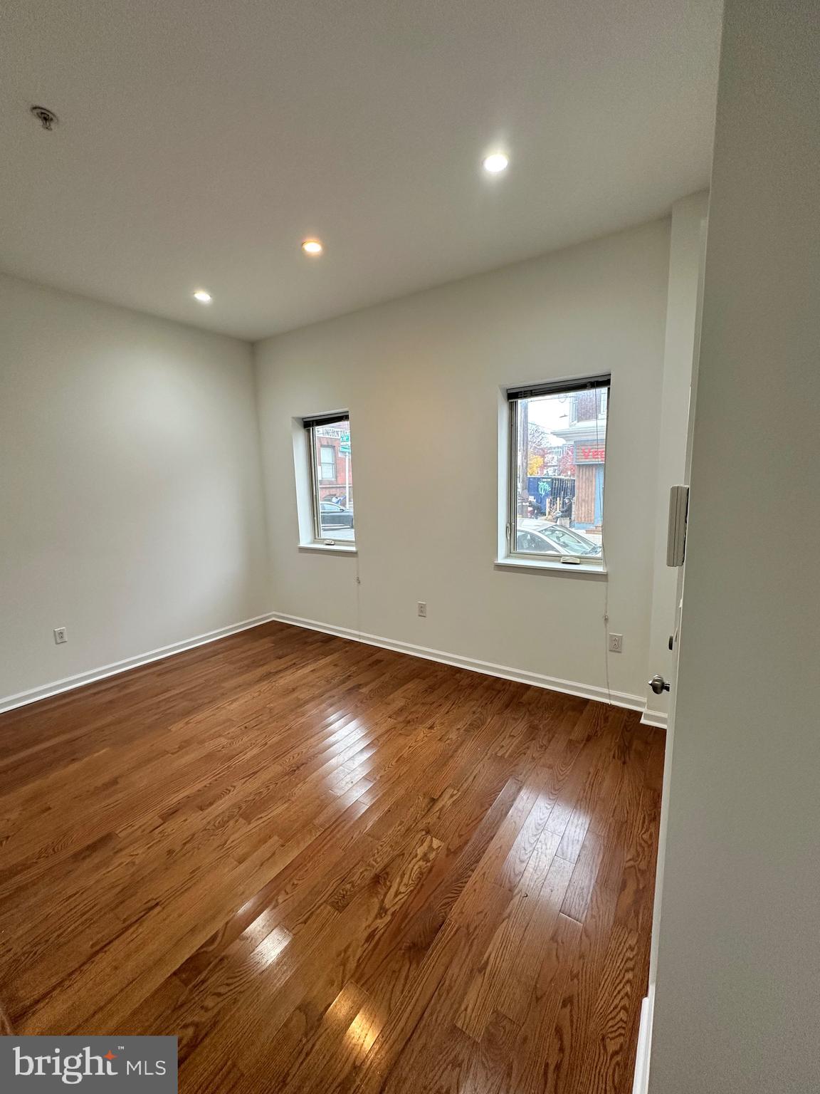1128 South 19th Street, Unit A Philadelphia, PA 19146 - Photo 6 of 17 an empty room with wooden floor and windows