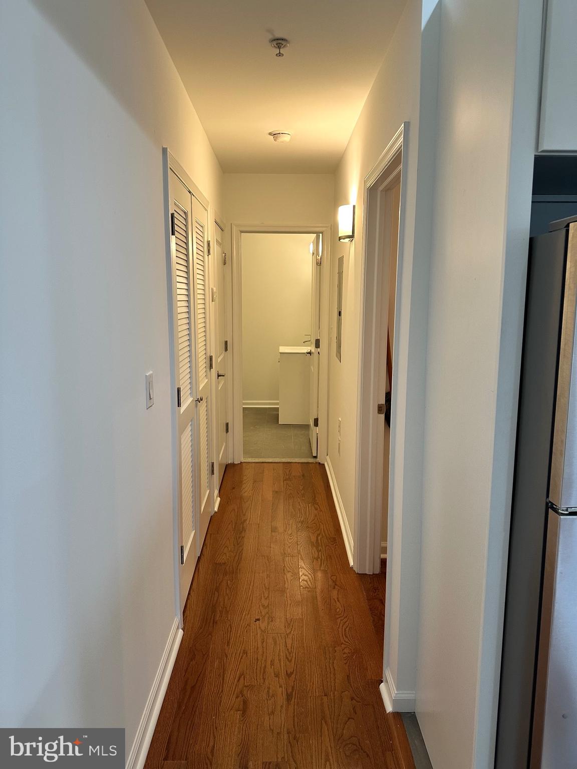 1128 South 19th Street, Unit A Philadelphia, PA 19146 - Photo 8 of 17 a view of a hallway with wooden floor and a bathroom