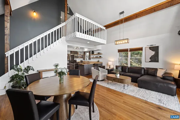 a living room with furniture and kitchen view