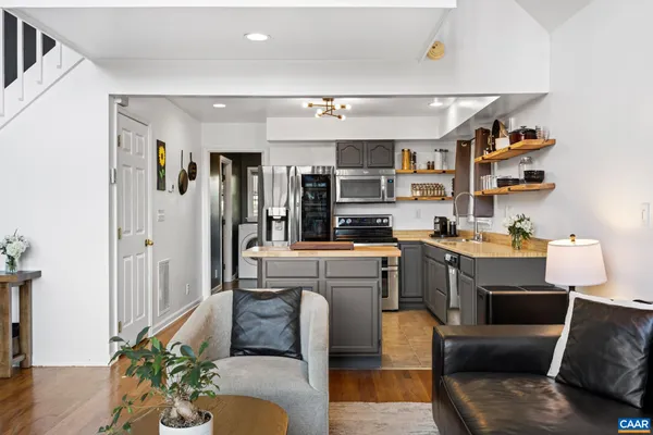 a kitchen with stainless steel appliances granite countertop a sink and stove