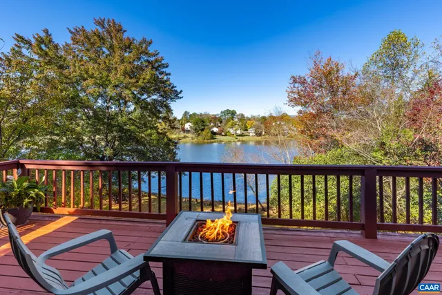 a view of a dining room with furniture a chandelier and wooden floor
