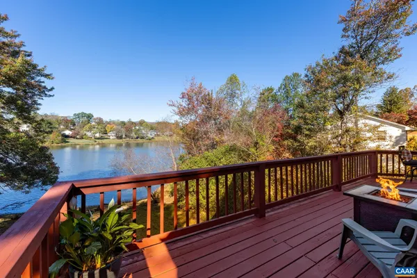 a view of deck with furniture and trees