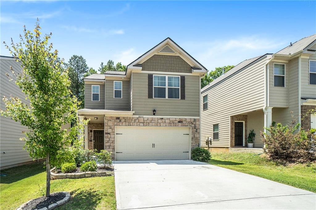 5031 Rapahoe Trail Atlanta, GA 30349 - Photo 1 of 1 a front view of a house with garden