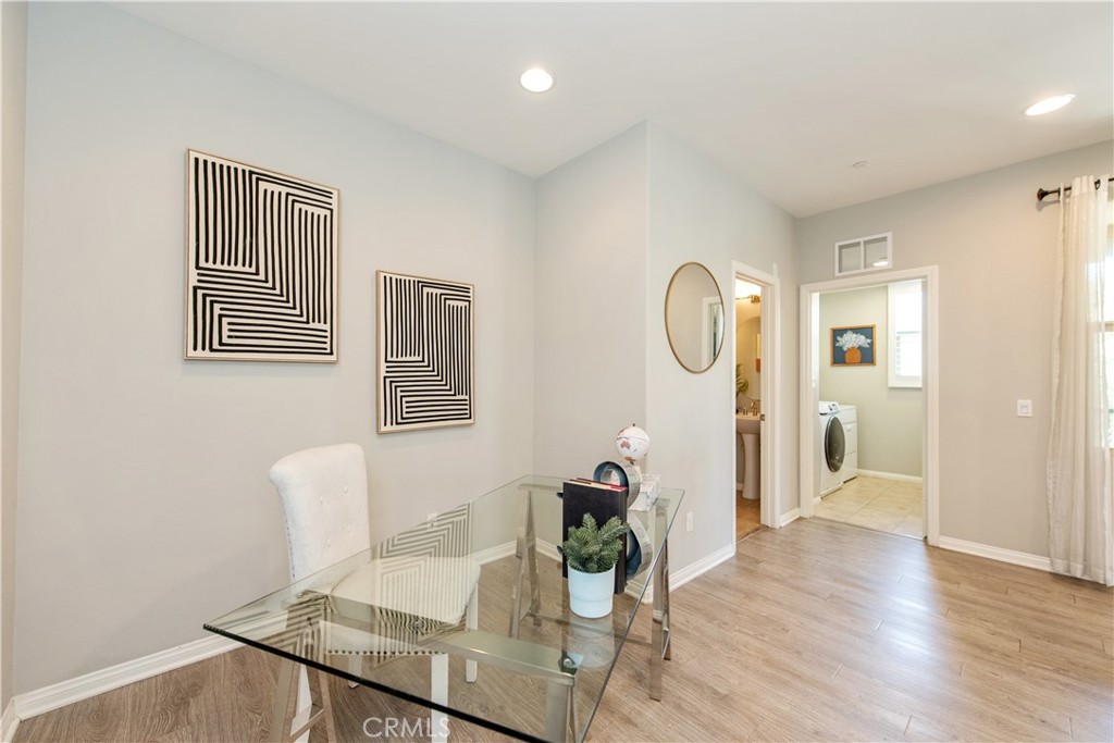68 Origin Irvine, CA 92618 - Photo 20 of 43 a living room with furniture a table and wooden floor