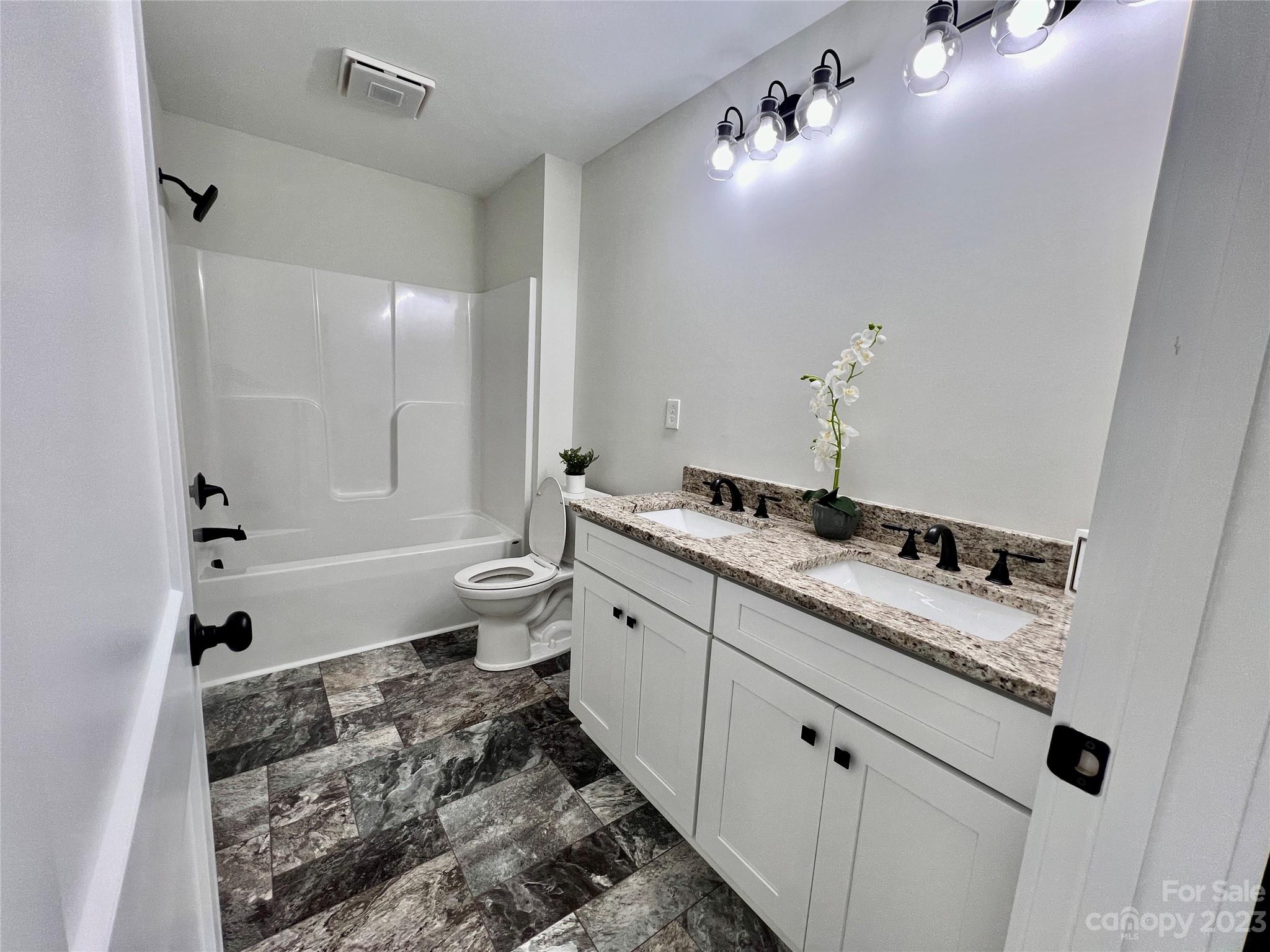 1907 Austin Chaney Road Wingate, NC 28174 - Photo 16 of 20 a bathroom with a double vanity sink toilet and shower