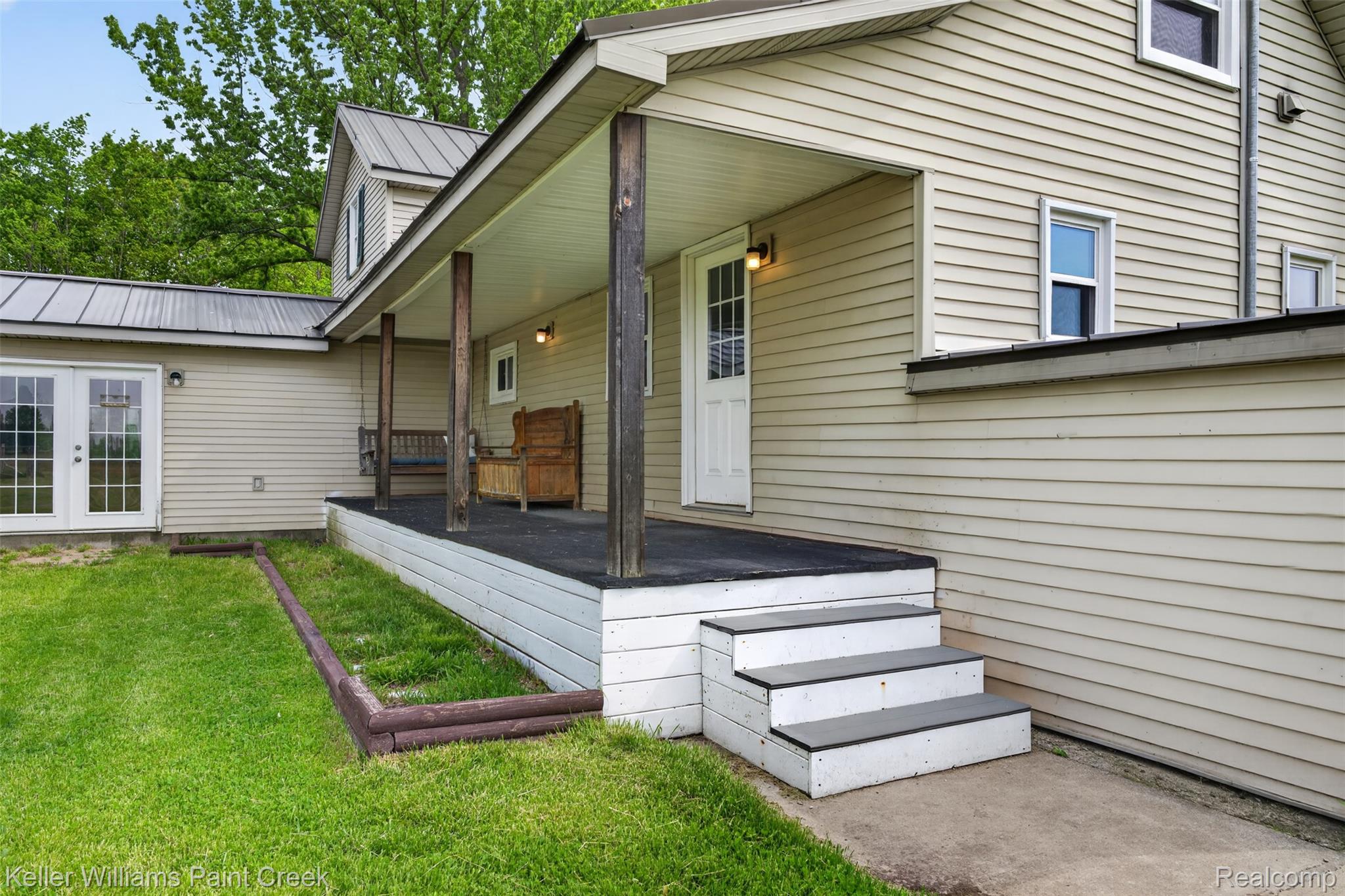 18125 Nelson Road St. Charles, MI 48655 - Photo 43 of 63 Property entrance featuring a metal roof, a yard, covered porch, and french doors