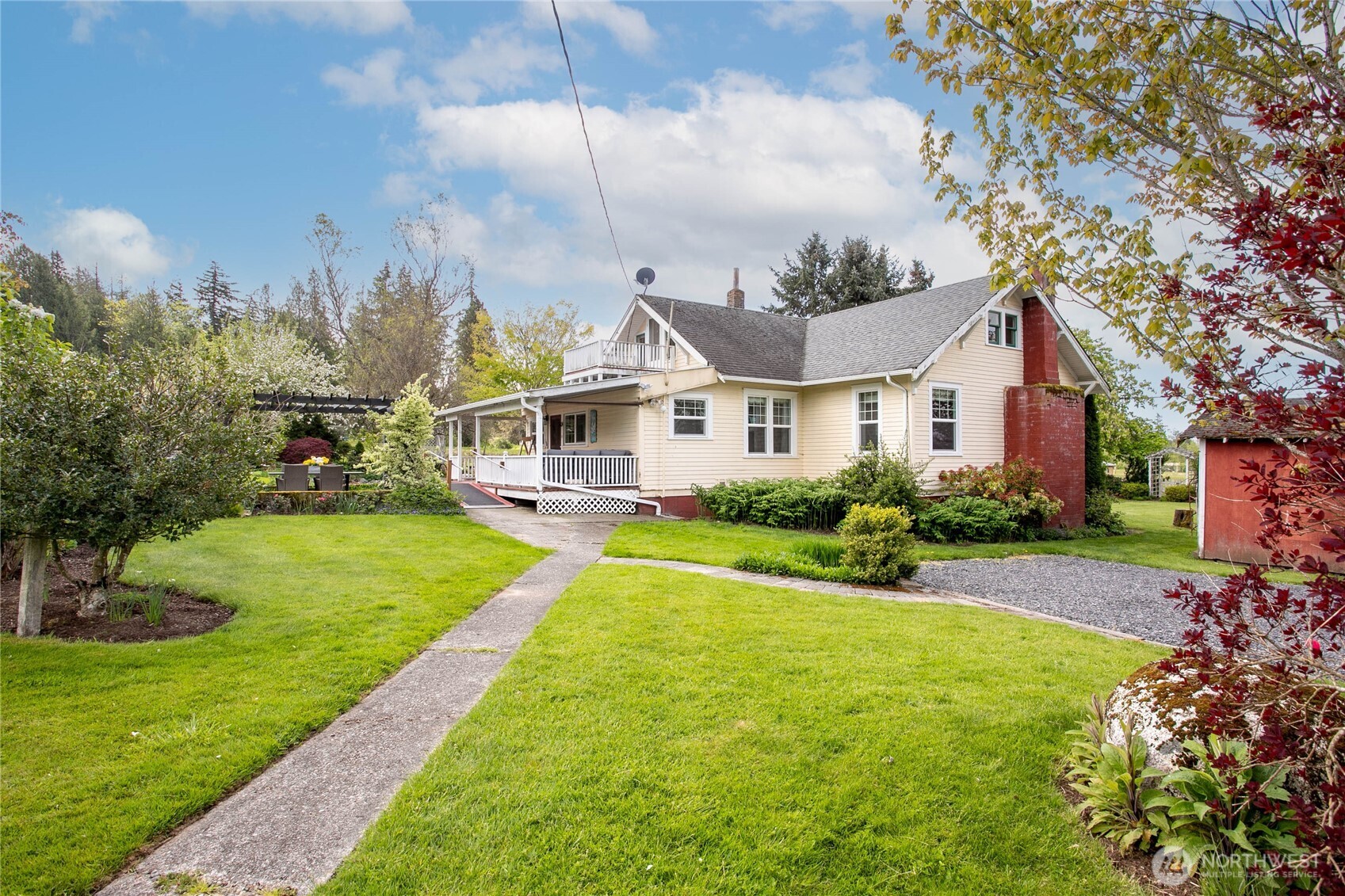 4918 Sand Road Bellingham, WA 98226 - Photo 34 of 39 a front view of a house with a yard table and chairs
